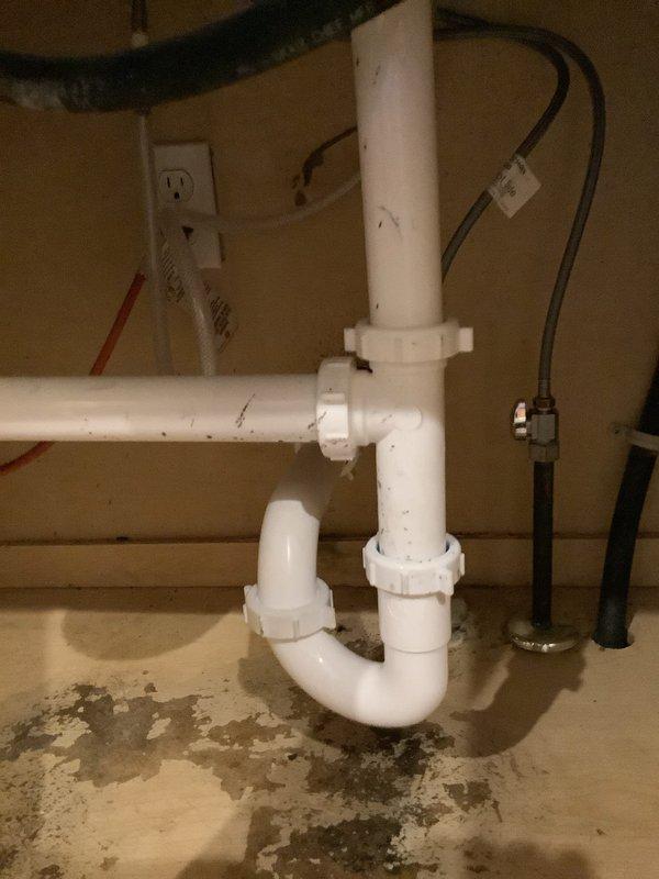 Completed installation of customer-supplied kitchen faucet with replacement of straight stops, snaked kitchen sink drain to clear backup, and replaced drain assembly with new basket strainer. Installed new PVC P-trap configuration under sink with proper connections to eliminate previous water staining/leakage issues observed during service.
