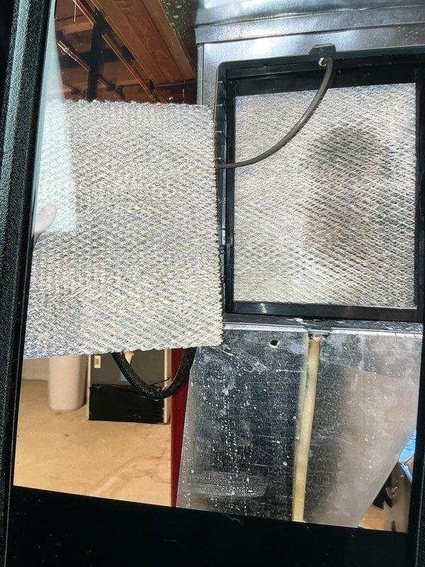 Completed scheduled heating maintenance service on 5-year-old system. Replaced air filters and inspected system components. Identified significant moisture issue with water pooling on concrete floor beneath unit and condensation on ceiling panels, suggesting possible drainage problem requiring further attention.