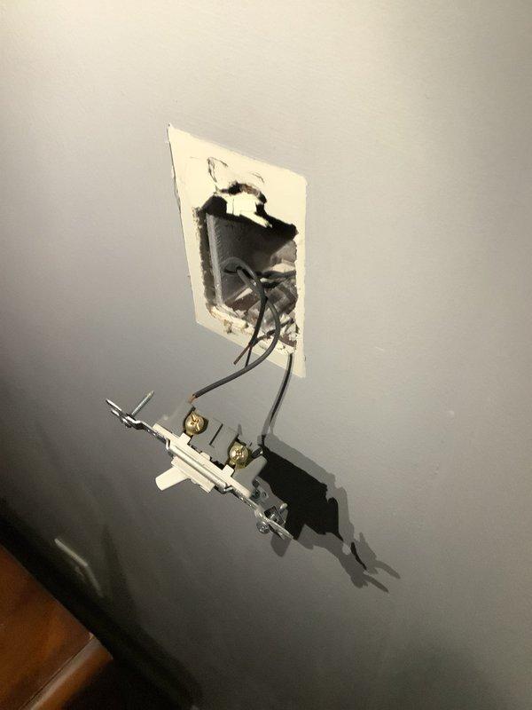 Responded to service call for four non-functional switches. Upon inspection, found two switch locations with improper installation - one with exposed wiring hanging from an unmounted electrical box and another with red/black conductors protruding from a rough-cut wall opening. Completed proper termination and secure mounting of all switches, ensuring proper function and code compliance.