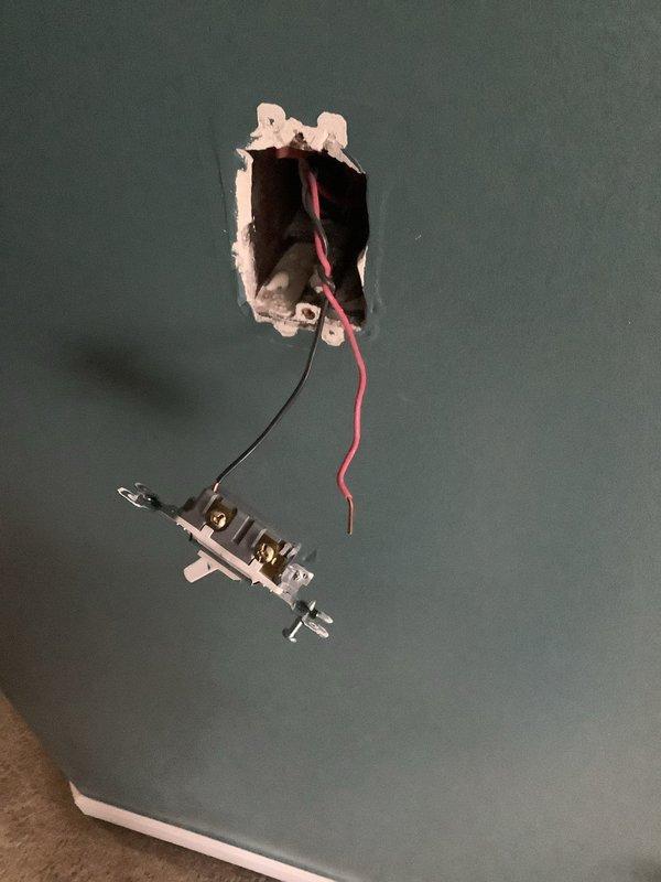 Responded to service call for four non-functional switches. Upon inspection, found two switch locations with improper installation - one with exposed wiring hanging from an unmounted electrical box and another with red/black conductors protruding from a rough-cut wall opening. Completed proper termination and secure mounting of all switches, ensuring proper function and code compliance.