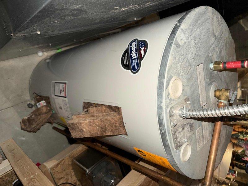 Performed comprehensive maintenance service on a 10-year-old tanked water heater, including inspection of copper pipe connections and flexible metal supply lines. Identified and addressed compressed insulation material around the tank base, and cleared debris from the utility area to ensure proper operation and extend equipment lifespan.