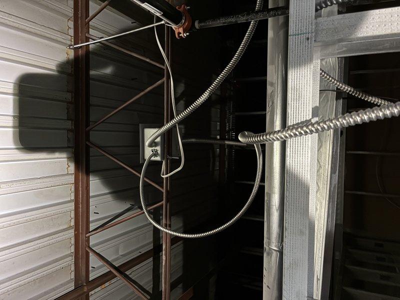 Investigated power issue with sauna unit by inspecting electrical connections and temperature control panel. Identified and traced metal conduits housing wiring through utility space to Finalaire SCAB control system. Verified functionality of temperature control dial, indicator light, and toggle switch components.