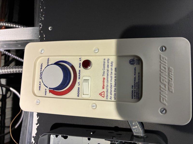 Investigated power issue with sauna unit by inspecting electrical connections and temperature control panel. Identified and traced metal conduits housing wiring through utility space to Finalaire SCAB control system. Verified functionality of temperature control dial, indicator light, and toggle switch components.