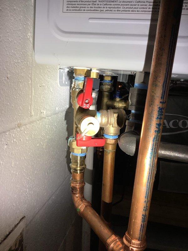 Completed tankless water heater flush service on unit with ENERGY STAR rating. Inspected all components including copper piping, pressure relief valves, and shut-off valves (red and blue handles). System was properly flushed to remove mineral buildup and restore optimal performance.