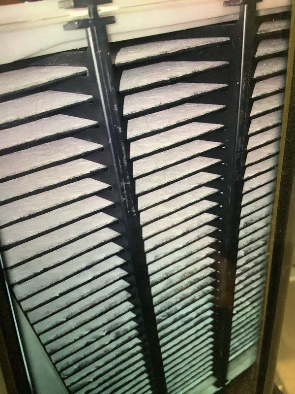 Conducted routine MVP heating maintenance service, which included inspection of the humidifier system mounted on ductwork. Observed significant dust accumulation on ventilation filter slats requiring cleaning. System appears to be functioning normally with no visible leaks or damage to the humidifier unit or connected PVC supply line.