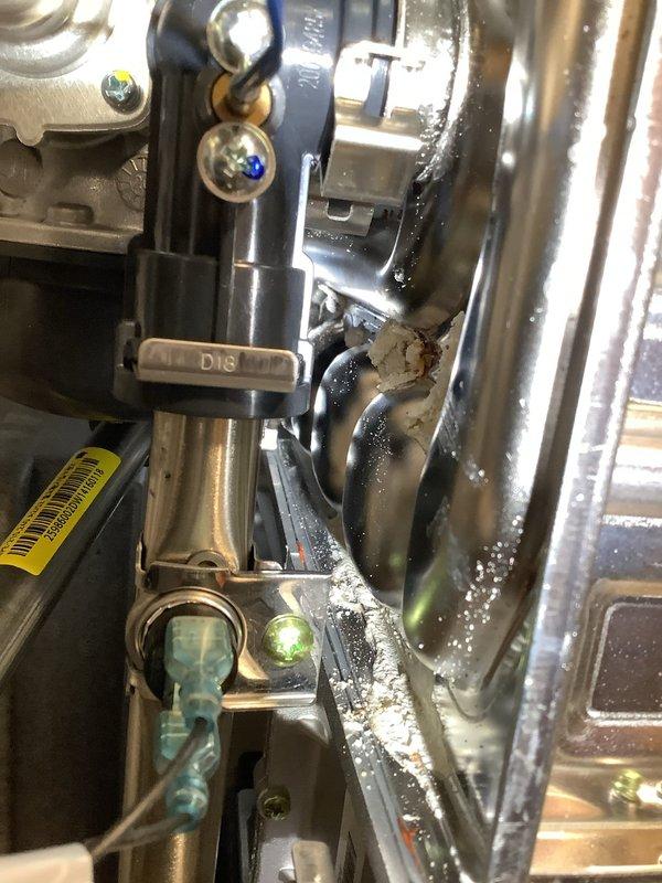 Performed diagnostic inspection on Navien tankless water heater producing insufficient hot water in 23-year-old residence. Examined internal components including condensing heat exchanger, valves, and connection points. Identified mineral buildup and partial blockage in heat exchanger unit affecting performance. Cleaned scale deposits and restored proper water temperature output.