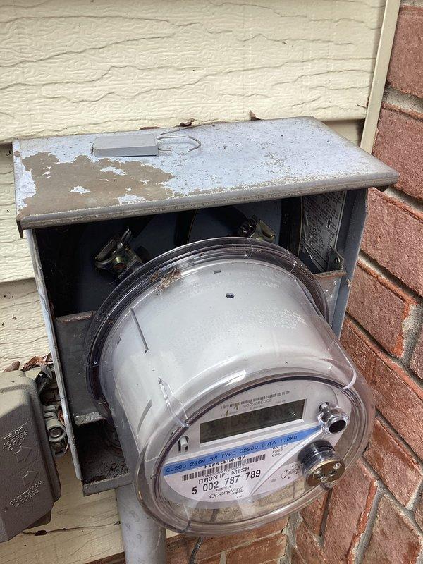 Responded to service call regarding electrical panel replacement. Inspected existing meter housing on brick exterior which showed weathering and paint deterioration. Documented condition of utility connection and surrounding area prior to beginning replacement work.