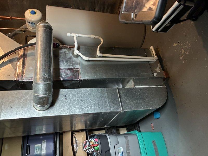 Performed routine maintenance on a 2-year-old furnace system. Inspected electrical connections and wiring integrity, noting proper wire nut connections and color-coding in the control panel. Examined the furnace installation including the flue vent, condensate drain lines, and confirmed proper PVC piping slope for adequate drainage.
