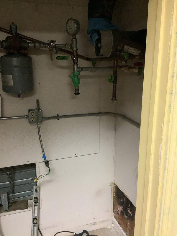 Conducted water heater assessment for natural gas unit replacement (no MVP). Documented existing installation including expansion tank, pressure regulator system, and associated copper plumbing. Observed significantly aged cylindrical unit with ventilation slots showing considerable wear, dirt accumulation, and possible corrosion. Second appointment will be scheduled once complete pricing estimates are prepared.