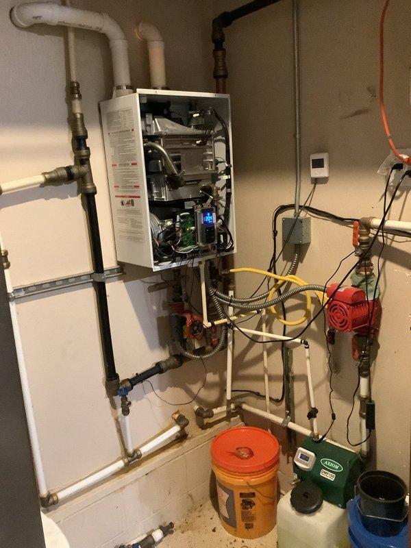Responded to service call for a tankless water heater system that was not properly supplying a garage heater and displaying error codes. Performed diagnostic inspection of the complete system including internal components, circulation pump, and associated PVC/copper piping configuration. Identified and resolved the issue causing the error codes, ensuring proper operation of both the tankless unit and the connected garage heating system.