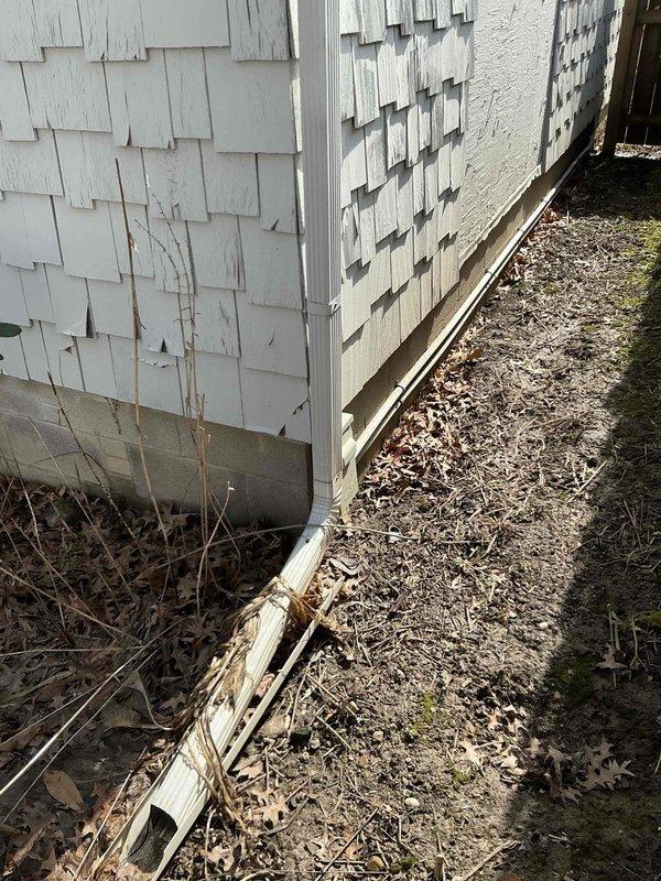 Conducted comprehensive assessment of 23-year-old furnace system with potential for AC addition as quoted. Inspection revealed weathered exterior siding with visible damage and an aging Trane furnace unit with standard galvanized ductwork in basement. Documented existing setup including connected humidifier/air purifier unit to provide replacement options for complete HVAC system upgrade.