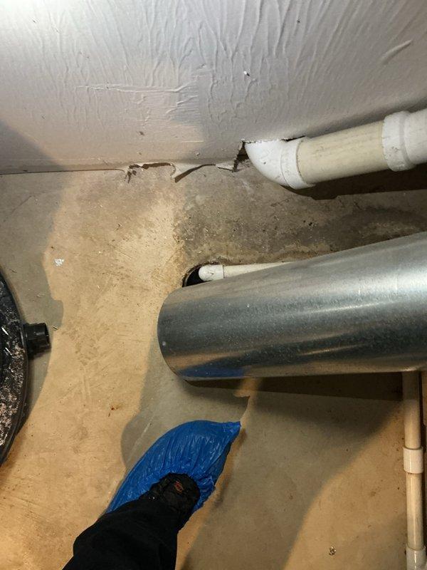 Conducted an on-site assessment for tankless water heater installation in a 36-year-old residence. Evaluated existing plumbing infrastructure, including copper supply lines, PVC drainage pipes, and current water heater system. Noted significant aging of components with visible mineral deposits and deterioration around pipe penetrations, which will require remediation during installation. Documented expansion tank condition and available utility connections for proper sizing and placement of new tankless unit.
