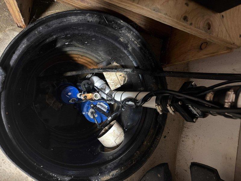 Responded to service call for sump pump alarm and non-functioning drainage. Upon inspection, found the submersible blue pump had failed due to sediment buildup at the bottom of the sump pit, causing the battery backup system to activate. Cleaned debris from pit, replaced faulty pump, tested system functionality, and verified proper operation of both primary pump and battery backup unit.
