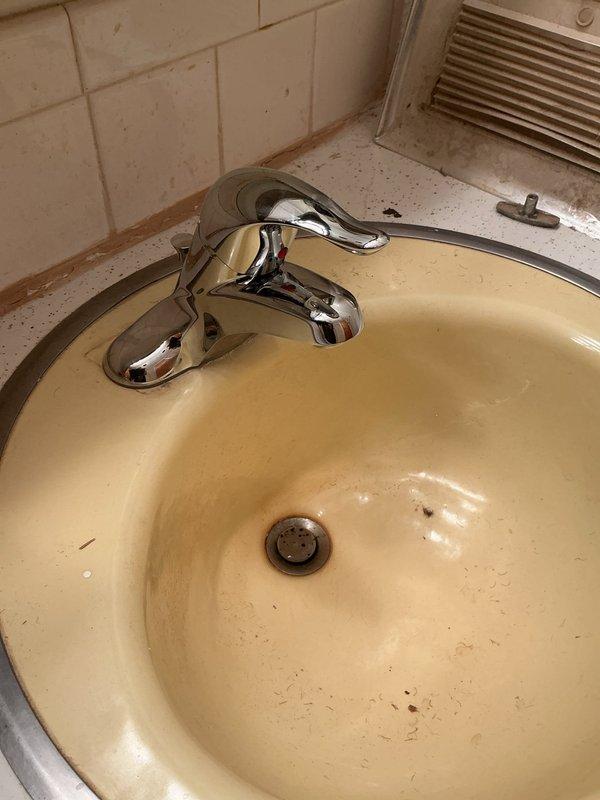 Completed replacement of three handle shower valves in bathroom with visible corrosion damage around tub drain area. Additionally, installed two new lavatory faucets and replaced angle stops to address aging fixtures showing significant wear and staining. All parts were pre-ordered, delivered to shop, and installation was completed as scheduled with photo documentation of deteriorated original fixtures.