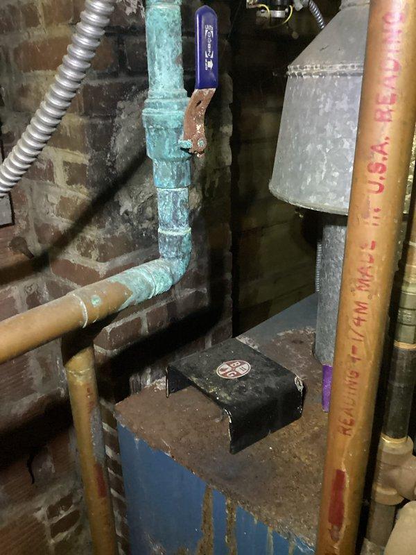 Performed scheduled maintenance on customer's boiler system. Identified significant copper pipe corrosion at the main water connection with blue-green oxidation, and inspected the gas line assembly including pressure regulator and shutoff valve. Documented condition of components with photos for future reference.
