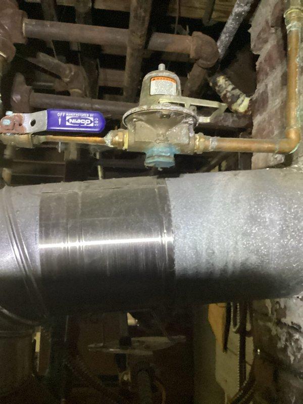 Performed scheduled maintenance on customer's boiler system. Identified significant copper pipe corrosion at the main water connection with blue-green oxidation, and inspected the gas line assembly including pressure regulator and shutoff valve. Documented condition of components with photos for future reference.