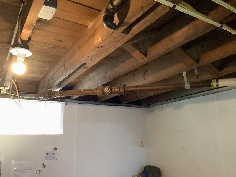 Performed inspection and replacement of deteriorated sewer line pipe in basement. Identified connection issues at the main stack and installed new ABS piping with proper fittings and supports attached to floor joists. Verified exterior connection points were properly sealed and tested system for leaks with successful results.