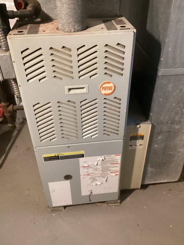 Performed comprehensive tune-up service on customer's 10-year-old Payne furnace and aging AC system per membership agreement. Inspected outdoor condenser unit, noting minor corrosion on fan components and metal casing, and cleaned accumulated debris from unit base. Serviced indoor furnace components, checked control systems, and verified proper operation of both heating and cooling systems. Recommended continued monitoring of condenser unit due to age-related wear.