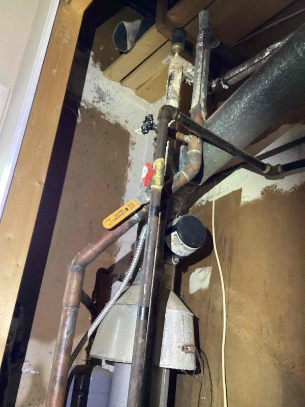 Responded to no-heat call for a 10-year-old furnace system. Diagnosed corroded gas line connections and oxidized copper piping in the utility area. Replaced gas valve, cleaned corroded fittings, and restored proper heating function after comprehensive system test.