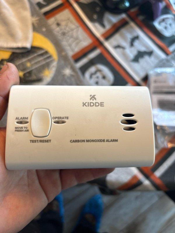 Completed installation of a 90K BTU air conditioning system with all required components. Installed a Kidde carbon monoxide alarm as part of the safety measures. Mounted DiversiTech junction box with proper conduit connections on exterior wall and installed PVC drain line for condensate removal.