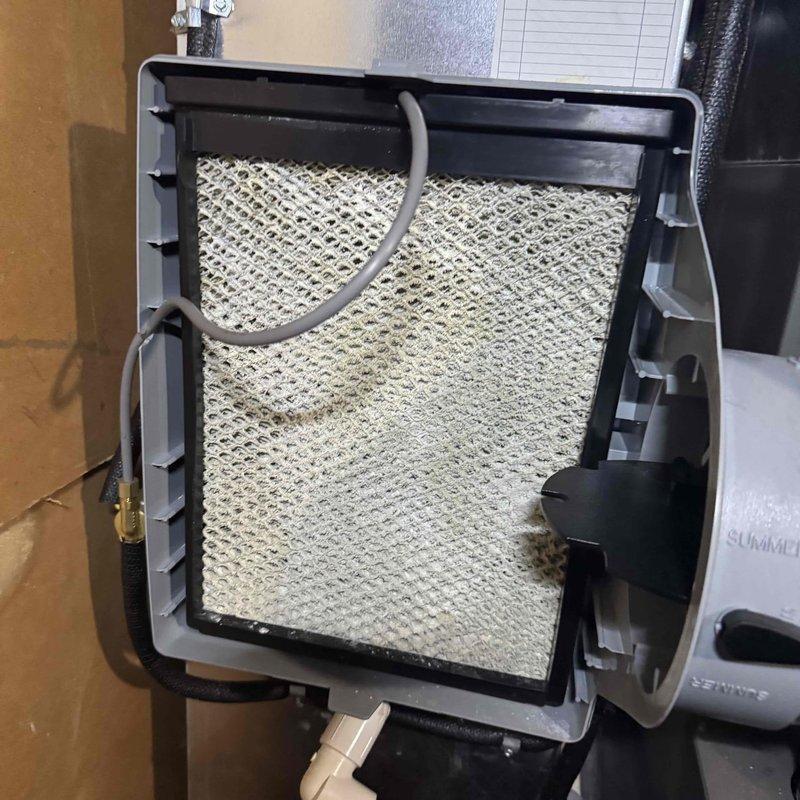 Responded to service call for a 4-year-old furnace leaking water onto carpet. Upon inspection, found humidifier with clogged filter element and drain line issues causing the water leak. Cleaned filter, cleared drainage system, and verified proper operation of unit before departure.