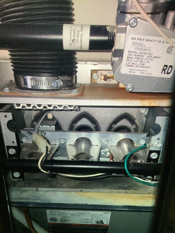 Performed scheduled MVP maintenance service on a 10-year-old furnace system. Inspected interior components including burners, heat exchangers, and wiring connections. Removed and examined ignition sensor bracket, cleaned components, and verified proper operation of the heating system.