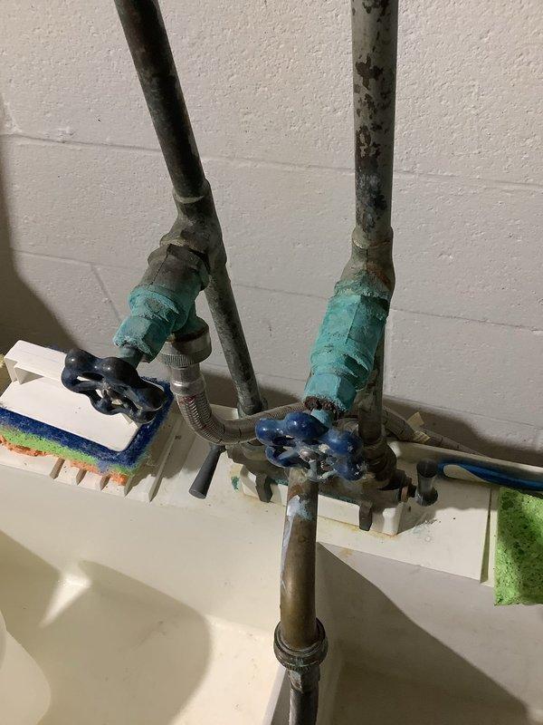 Responded to emergency water leak in basement of 65-year-old home. Located and operated main water shut-off valve which had significant corrosion and oxidation on copper pipes and valves. Addressed water accumulation and educated homeowner on location of main water valve for future reference.