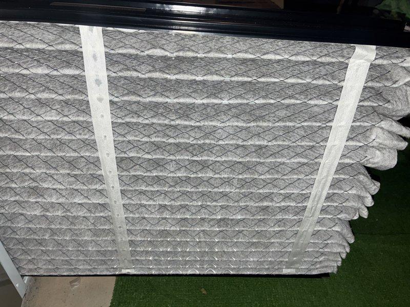 Performed routine maintenance on furnace of undetermined age. Inspected and replaced air filters with new diamond-patterned mesh filters. Examined control board circuitry and wiring connections (white, blue, yellow, green, red, black, and pink terminals) for proper functionality, all components found in normal working condition with no visible abnormalities.