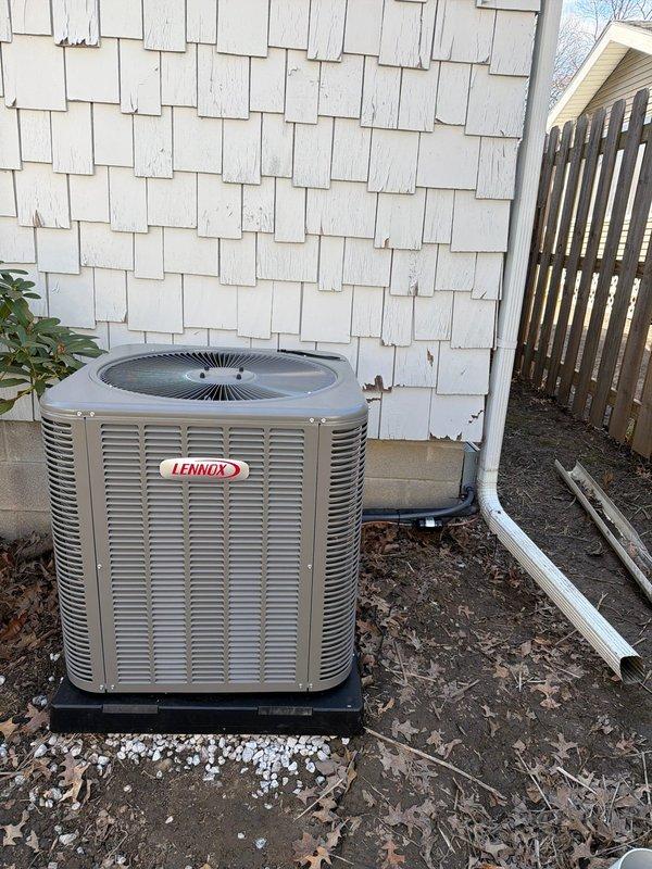 Completed installation of a new complete HVAC system, including a Trane furnace with connected ductwork in the basement utility area and a Lennox outdoor AC condenser unit (80 AC 600 model). System was properly mounted with all necessary connections, including refrigerant lines running to the house, and the outdoor unit was positioned on a mounting pad adjacent to the home's exterior.