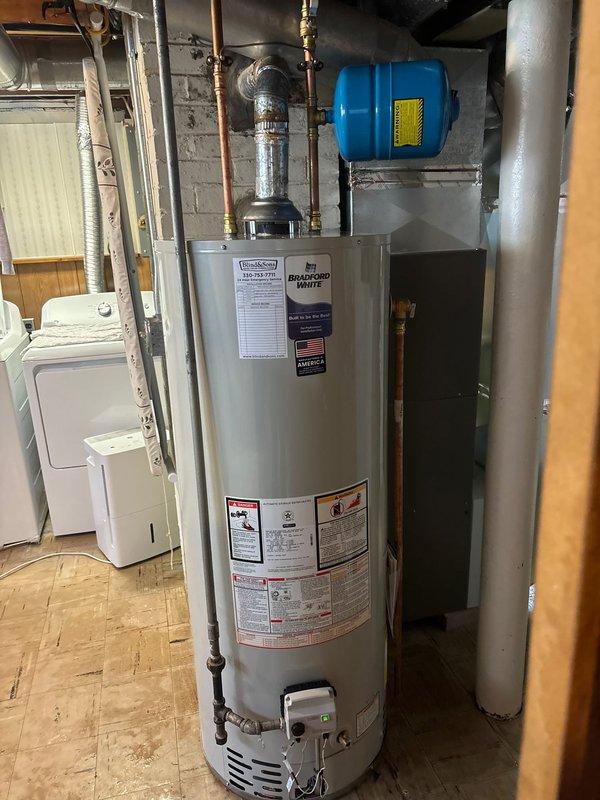 Installed new 50-gallon tall Bradford White water heater with all required connections, including copper piping, expansion tank, and proper venting system. Completed installation of new shower valve as specified in the original work order. All components were properly fitted and secured according to manufacturer specifications, with system tested for proper operation before completion.