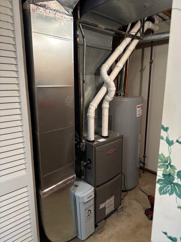 Completed installation of new Lennox furnace with proper PVC venting configuration. Installed Kidde carbon monoxide alarm as safety measure. System includes integrated humidifier and was verified operational with all connections secure and properly sealed.
