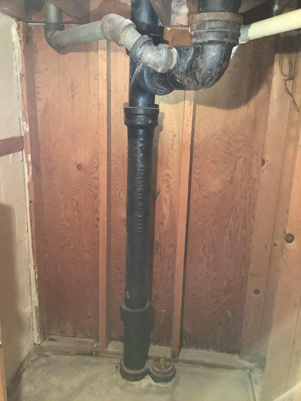 Cleared a severely clogged wash basin drain line on the second floor requiring replacement of approximately 9.5 feet of drain pipe. Installed new drainage components including proper P-trap configuration and ensured connection to the main cast iron waste stack. System now functioning properly with no leaks observed during testing.
