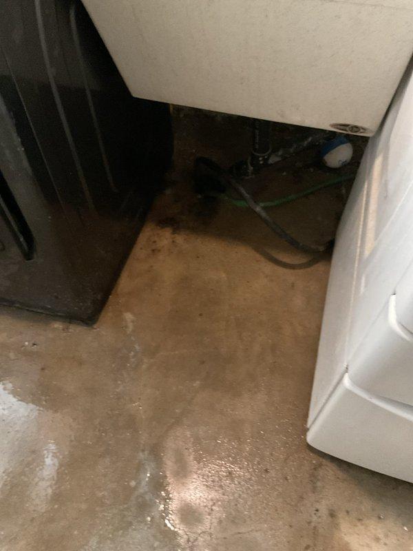 Responded to a service call for a laundry drain backup in the basement. Upon inspection, found standing water and moisture around the utility area with the blockage occurring in the main drain line connected to the laundry appliances. Successfully cleaned out the clogged drain line, restoring proper drainage functionality and preventing further water accumulation on the concrete floor.