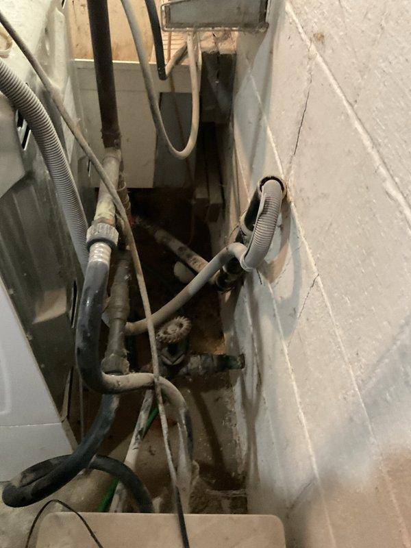 Responded to a service call for a laundry drain backup in the basement. Upon inspection, found standing water and moisture around the utility area with the blockage occurring in the main drain line connected to the laundry appliances. Successfully cleaned out the clogged drain line, restoring proper drainage functionality and preventing further water accumulation on the concrete floor.