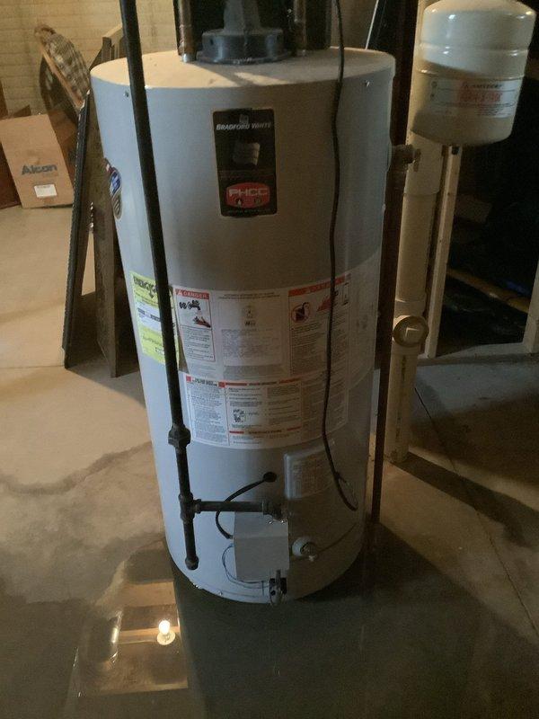 Responded to service call for leaking tanked water heater. Upon inspection, identified and repaired leak source on Bradford White unit. Verified proper operation of expansion tank and all connected plumbing lines, ensuring system was functioning correctly with no further leaks present.