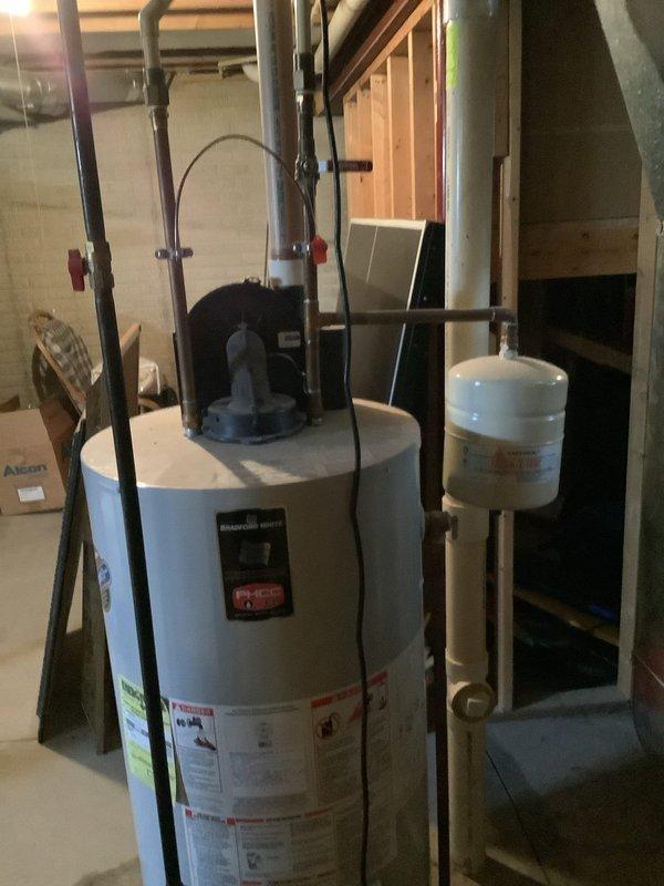 Responded to service call for leaking tanked water heater. Upon inspection, identified and repaired leak source on Bradford White unit. Verified proper operation of expansion tank and all connected plumbing lines, ensuring system was functioning correctly with no further leaks present.