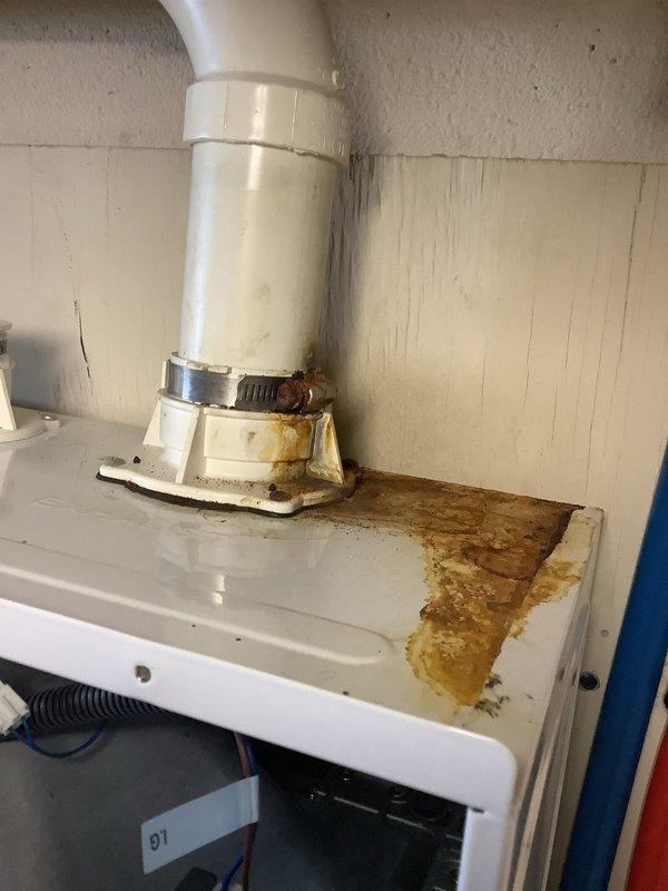 Successfully replaced the damaged exhaust collar port on the Navien tankless water heater unit that showed significant water damage and rust staining at the connection point. Installed new PVC piping with proper sealing to prevent future condensation issues and ensure proper venting of the system.