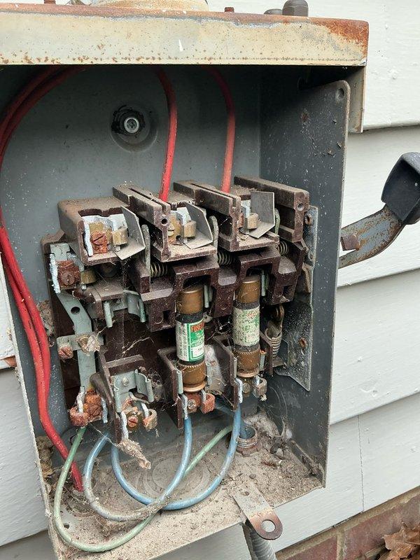 Performed scheduled MVP Cooling maintenance service and documented significant corrosion in the electrical disconnect box, including deteriorated contacts and rust on fuse connections. Observed moisture accumulation and early-stage corrosion on the evaporator coil fins (units 4 and 5), indicating potential condensate drainage issues that could impact system efficiency.