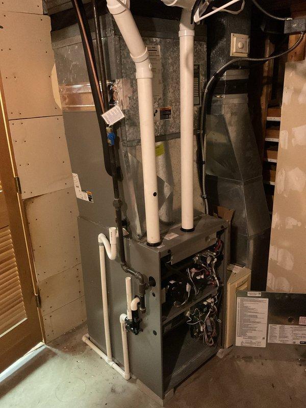 Performed scheduled MVP Cooling maintenance visit. Inspected residential HVAC system including furnace with PVC exhaust. Replaced air filter with visible accumulation of particulates, ensuring proper airflow for optimal cooling system operation.