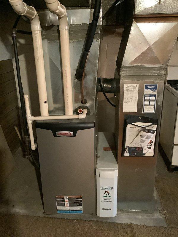 Performed routine maintenance on 10-year-old Lennox furnace. Inspected evaporator coil showing signs of dirt accumulation/oxidation and verified proper condensate drain line operation. System appears operational with all components properly connected, though coil may require cleaning at next service interval.