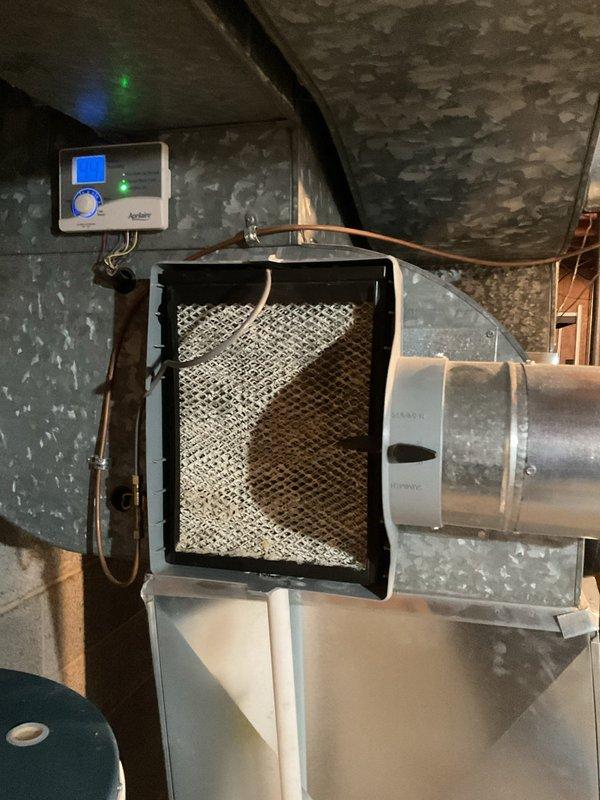 Responded to water leak complaint in basement. Inspected HVAC system including furnace with connected ductwork and humidifier unit. Discovered hole in condensate line causing water accumulation; repaired damaged section and verified proper drainage function to resolve the leak issue.