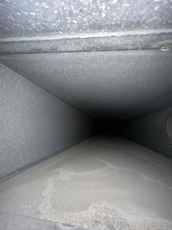 Completed comprehensive duct cleaning service on two HVAC systems comprising approximately 40 vents. Visual inspection revealed accumulated debris at duct bases and connection points. Thoroughly cleaned all main trunk lines, branch ducts, and supply/return vents, removing dust and contaminants from the rectangular sheet metal ductwork and insulated surfaces.