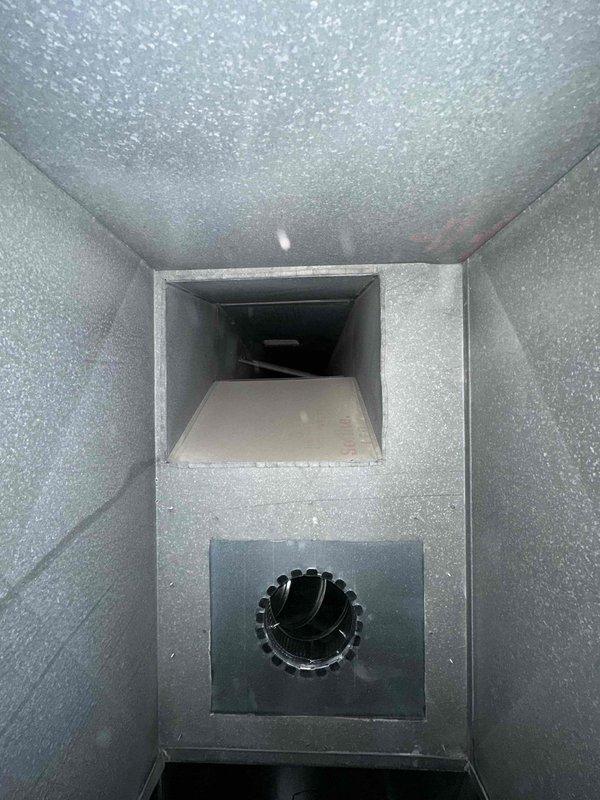Completed comprehensive duct cleaning service on two HVAC systems comprising approximately 40 vents. Visual inspection revealed accumulated debris at duct bases and connection points. Thoroughly cleaned all main trunk lines, branch ducts, and supply/return vents, removing dust and contaminants from the rectangular sheet metal ductwork and insulated surfaces.