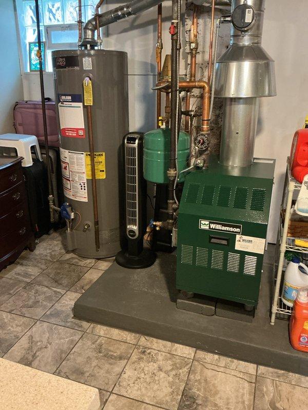 Performed scheduled water heater flush service on Ruud Professional tanked water heater. Connected drainage hose to bottom valve and thoroughly flushed system to remove sediment buildup. Inspected unit, connections, and expansion tank for proper operation after service completion.