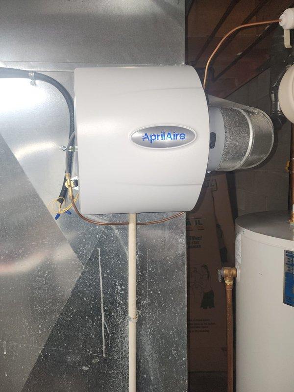 Successfully installed and connected an AprilAire model AA600 whole-home humidifier to the return ductwork in the utility room. System was properly mounted, water supply lines connected, and control panel configured. Verified proper operation with the existing HVAC system.