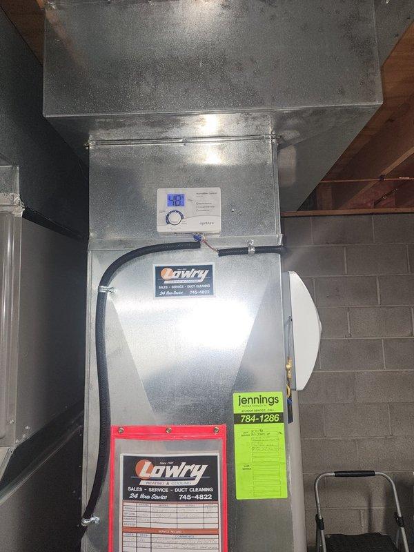Successfully installed and connected an AprilAire model AA600 whole-home humidifier to the return ductwork in the utility room. System was properly mounted, water supply lines connected, and control panel configured. Verified proper operation with the existing HVAC system.
