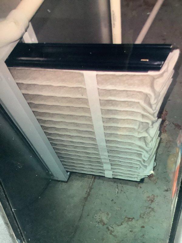 Performed routine MVP furnace maintenance and installed a new water panel for humidification system. Inspected air filtration components and secured filter assembly with proper vertical strapping. Noted water staining on basement floor beneath unit, potentially indicating previous condensate drainage issues.