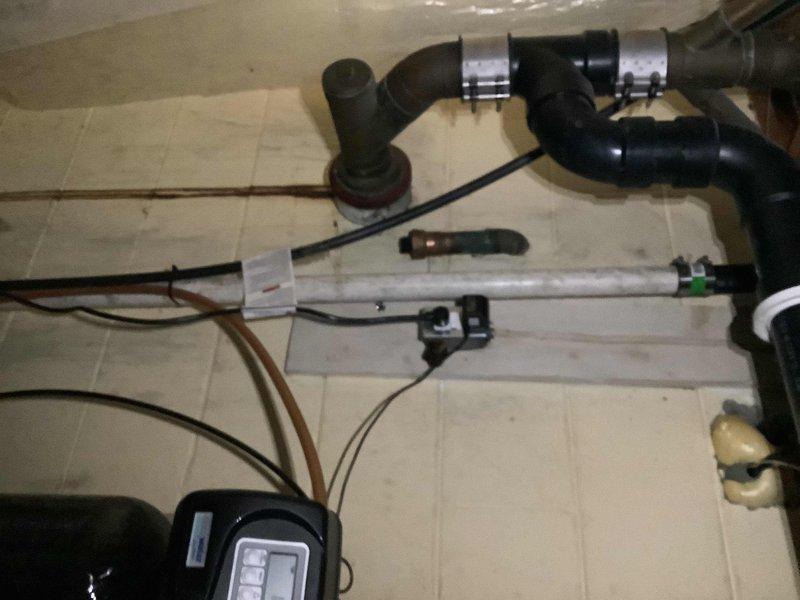 Completed sump pump replacement in 60-year-old home with failing drainage system. Installed new PVC discharge lines with secure metal clamps and connected electrical components to digital controller. Addressed visible moisture issues in basement area while ensuring proper drainage configuration for optimal performance.