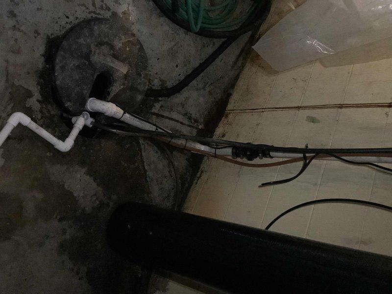 Completed sump pump replacement in 60-year-old home with failing drainage system. Installed new PVC discharge lines with secure metal clamps and connected electrical components to digital controller. Addressed visible moisture issues in basement area while ensuring proper drainage configuration for optimal performance.