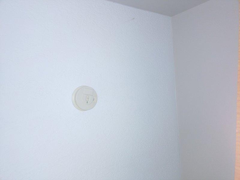 Replaced six hard-wired smoke detectors throughout the residence with new units. Verified proper installation and functionality of all detectors to ensure compliance with safety standards. All units are now operational with indicator lights functioning correctly.